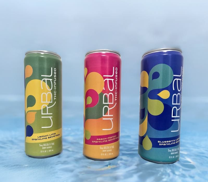 Three colorful URBAL THC-infused beverage cans on a blue, watery background.