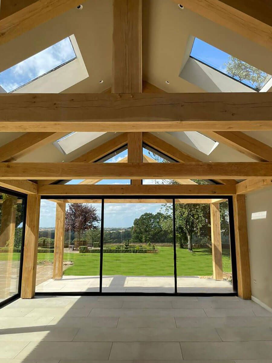 Exposed timber-framed structure to pool house