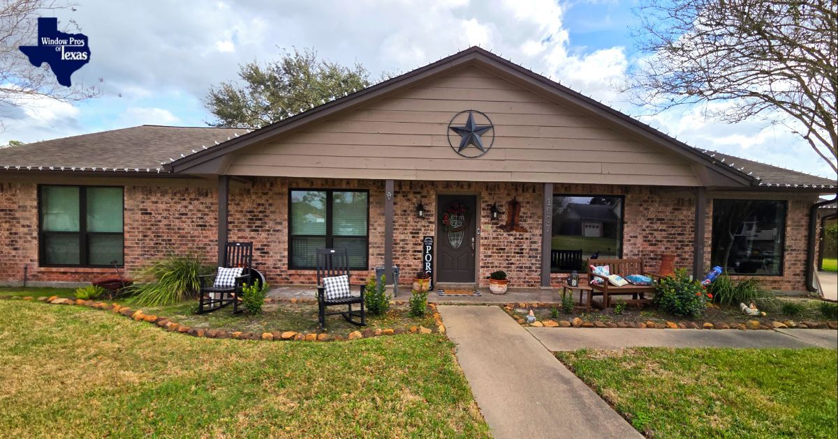 Brick house with a porch. A Texas star decorates the gable. Two chairs sit on the porch.