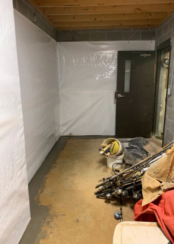 A room with a white wall and a door.