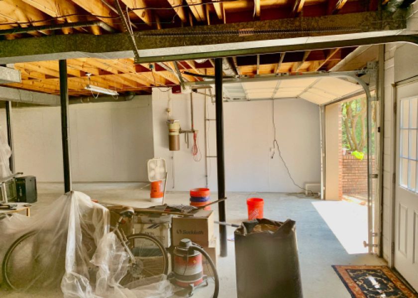 An empty garage with a vacuum cleaner in it