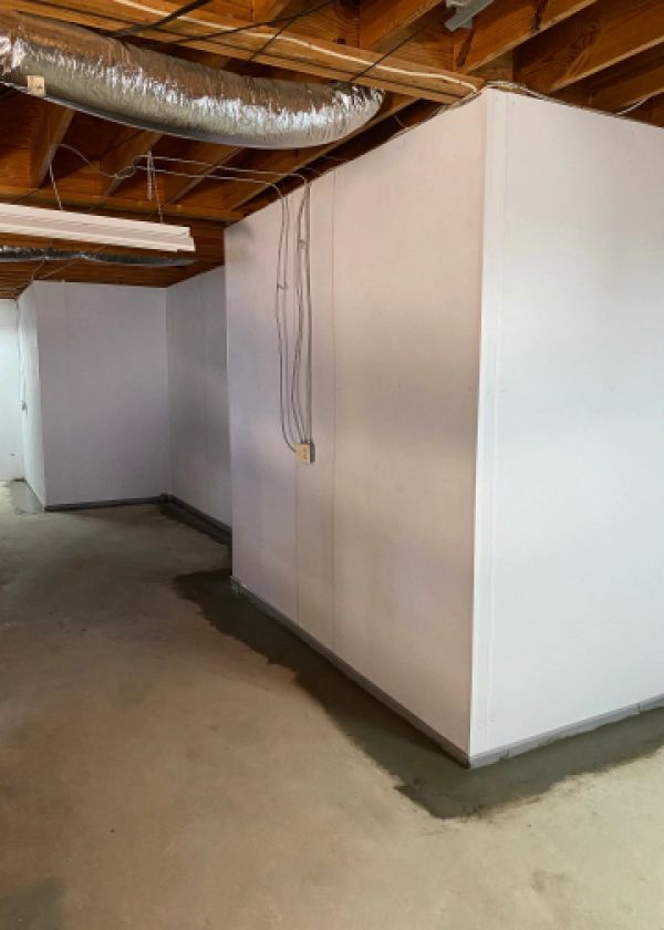 A basement with white walls and a concrete floor.