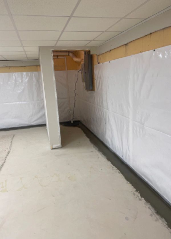 A basement with white walls and a concrete floor.