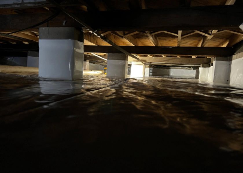 A flooded basement with a lot of water coming out of it.