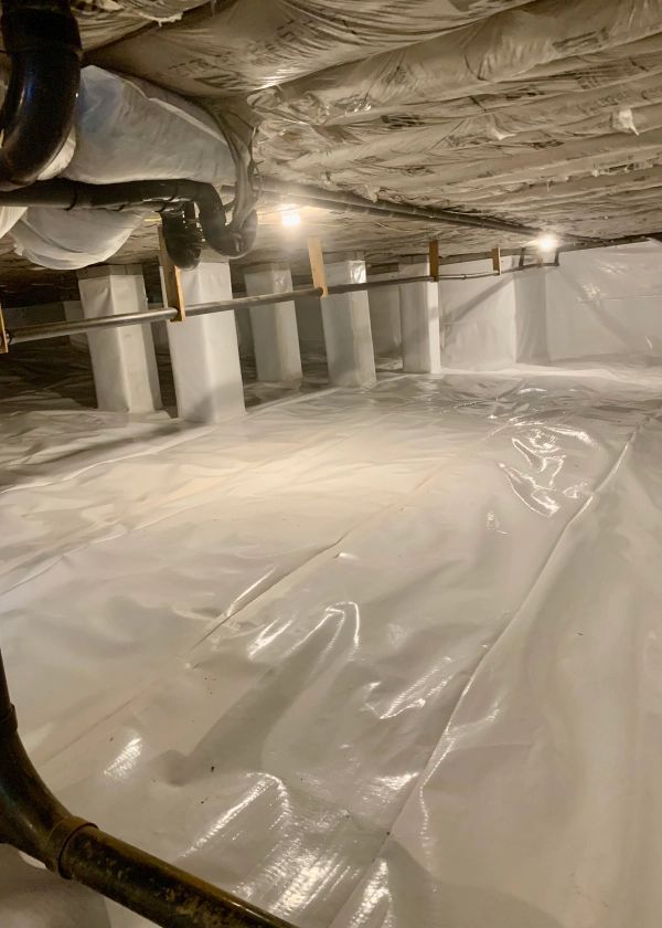 A basement with a lot of plastic covering it.