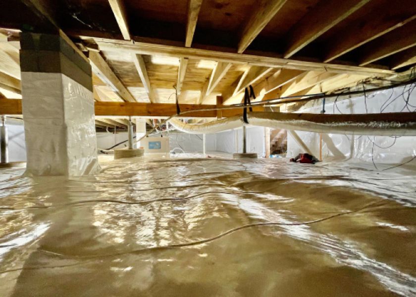 A basement under construction with a lot of plastic covering the floor.
