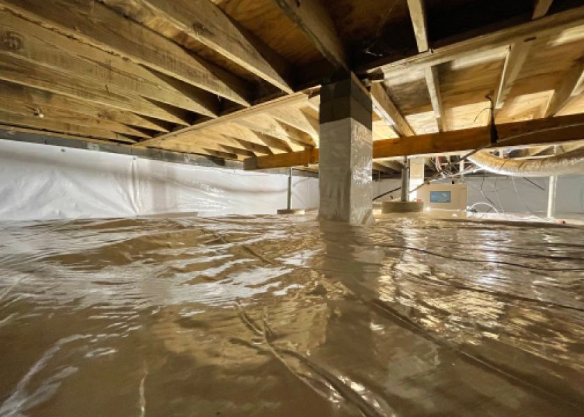 A basement with a lot of plastic on the floor.