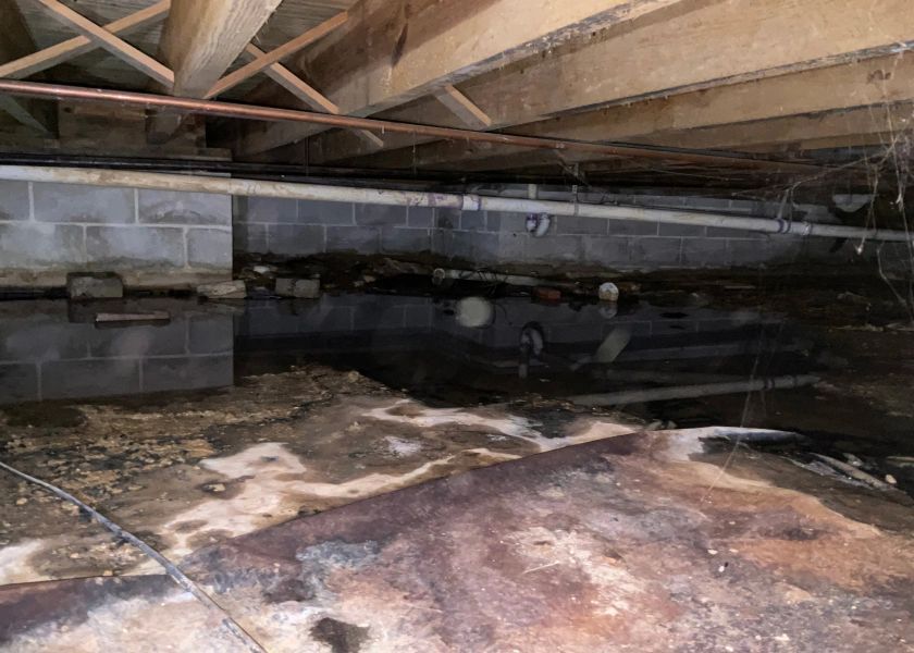 A flooded basement with a lot of water coming out of it.