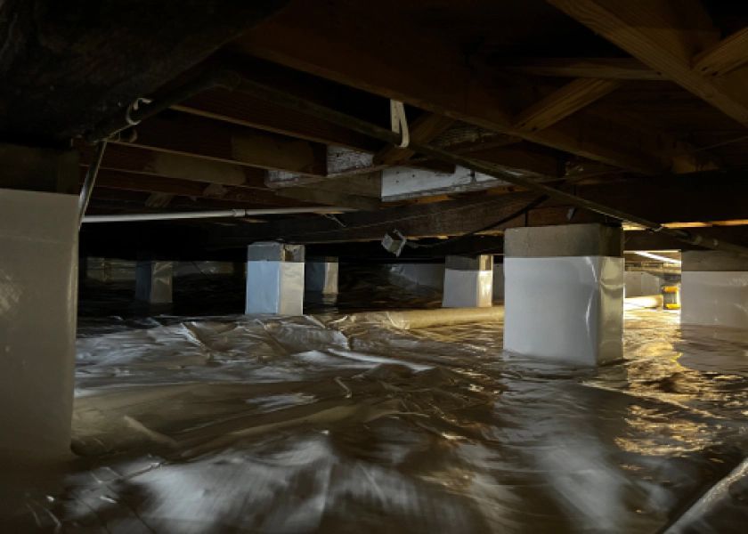 A flooded basement with a lot of water coming out of it.