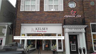 A brick building with a white sign that says kelsey on it.