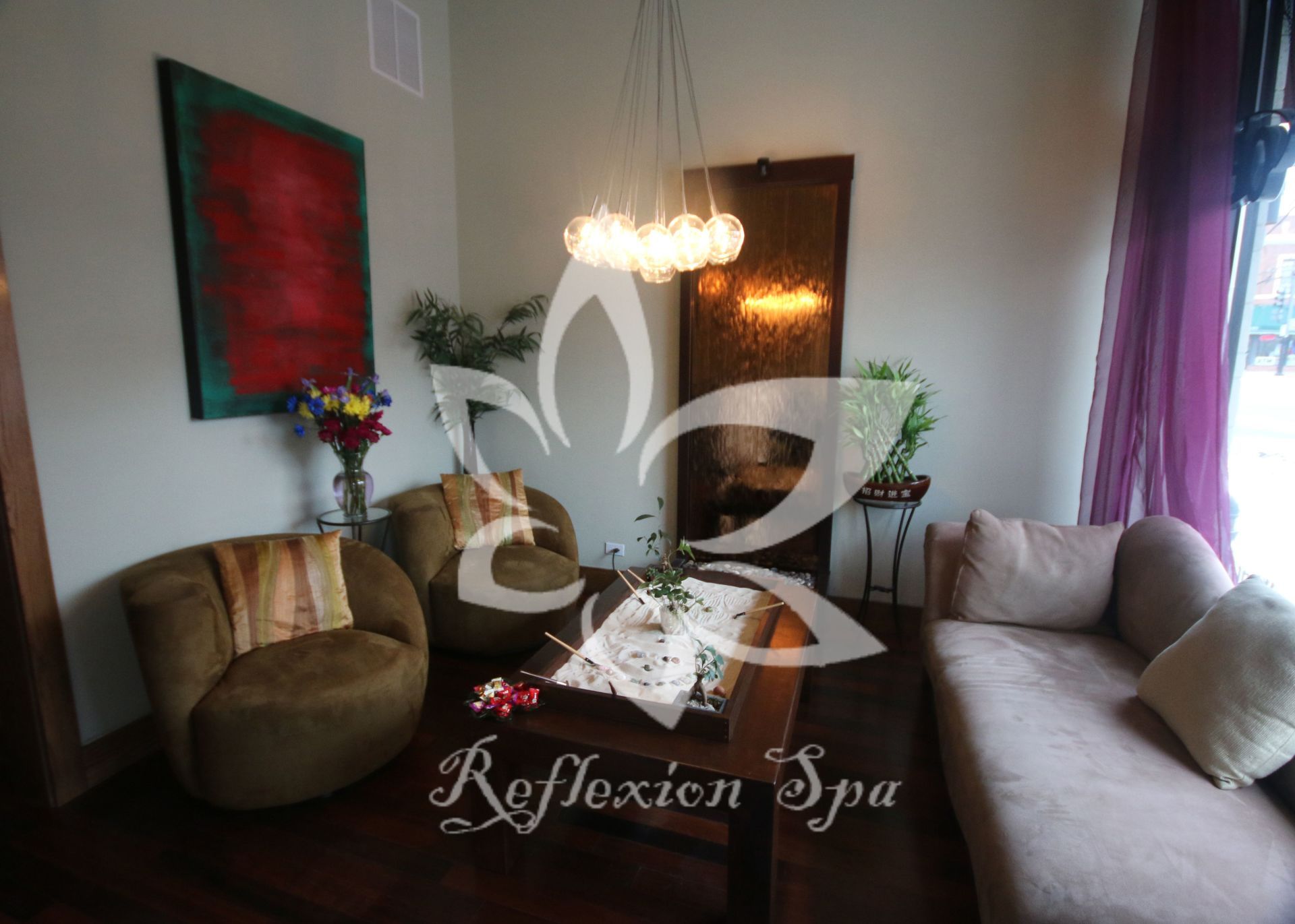 A living room with a couch and chairs and the words reflexion spa on the wall