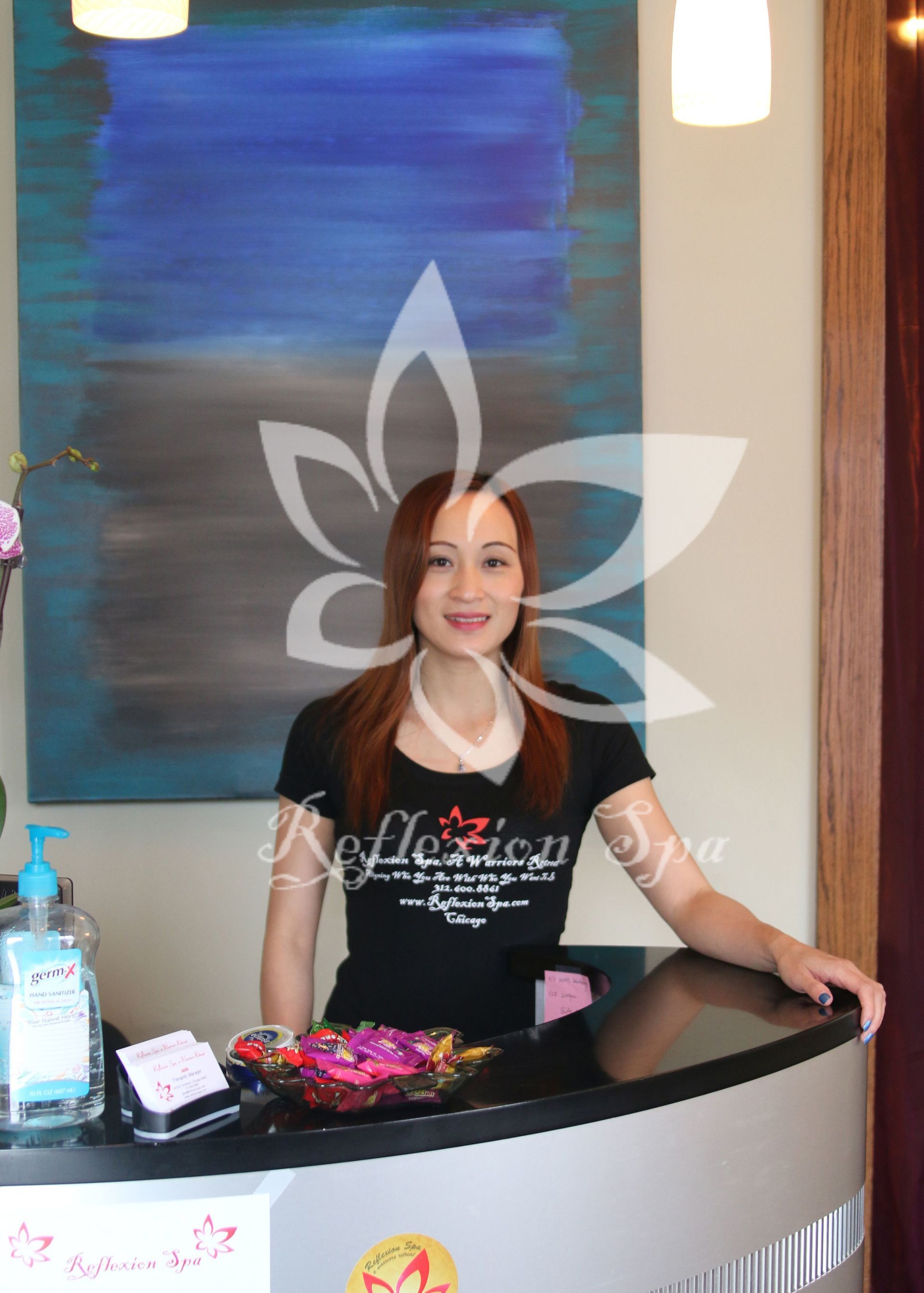 A woman is standing behind a counter in a spa