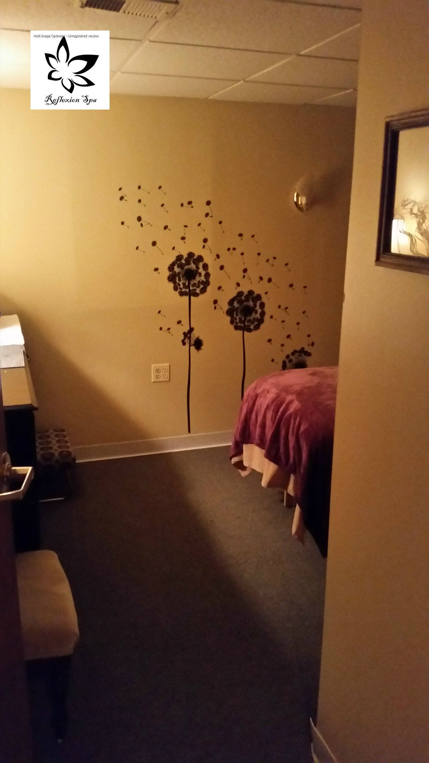 A room with a bed and dandelions on the wall