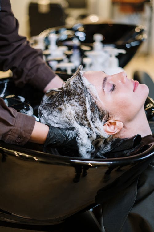 Woman getting a shampoo treatment at a salon