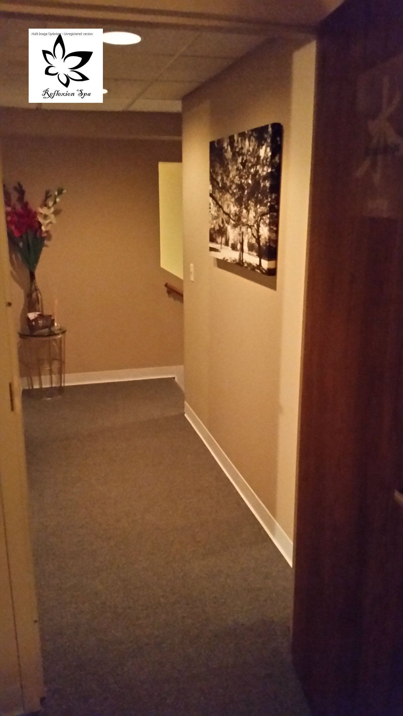 A long hallway with a painting on the wall