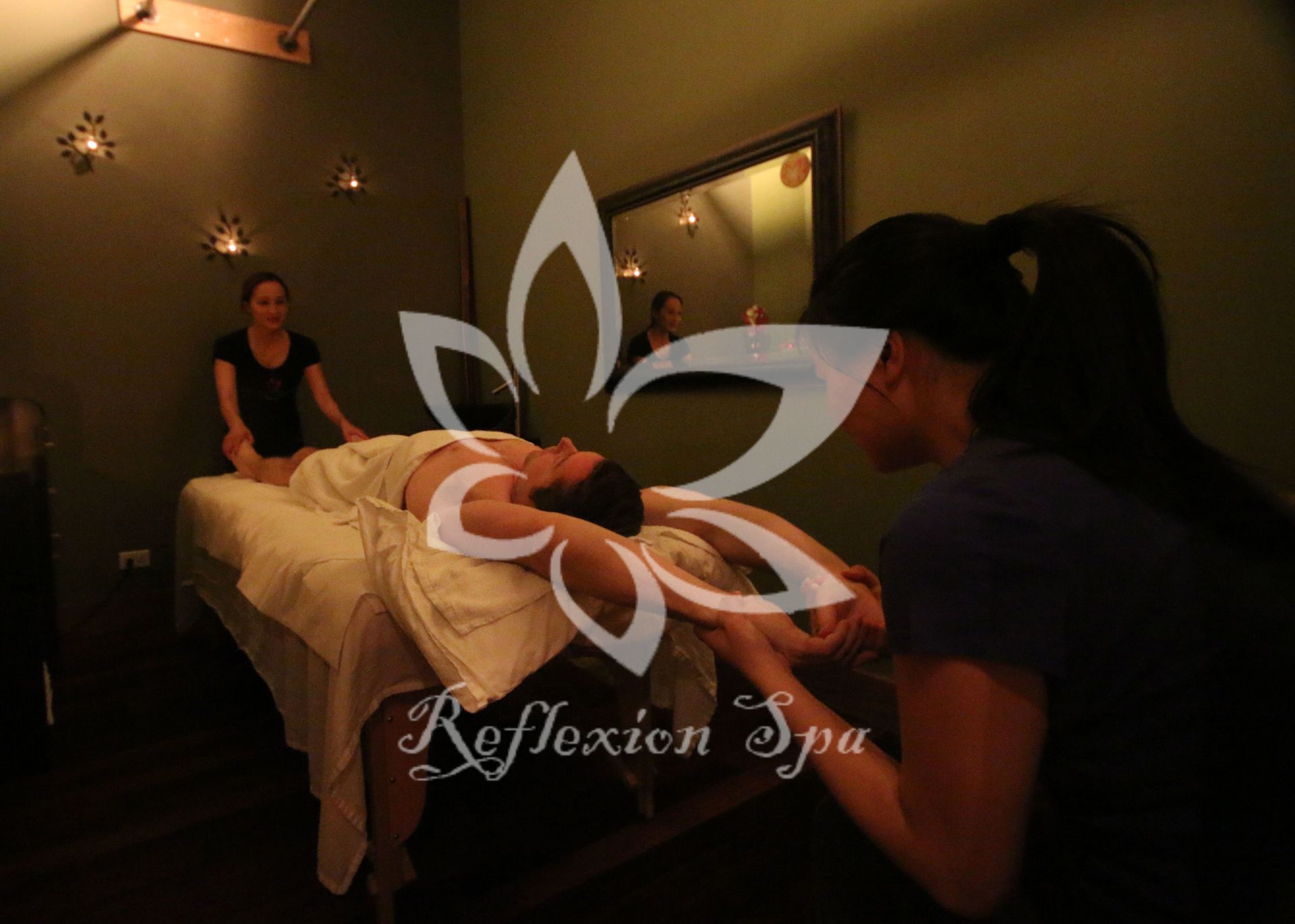 A woman is getting a massage in a reflexion spa