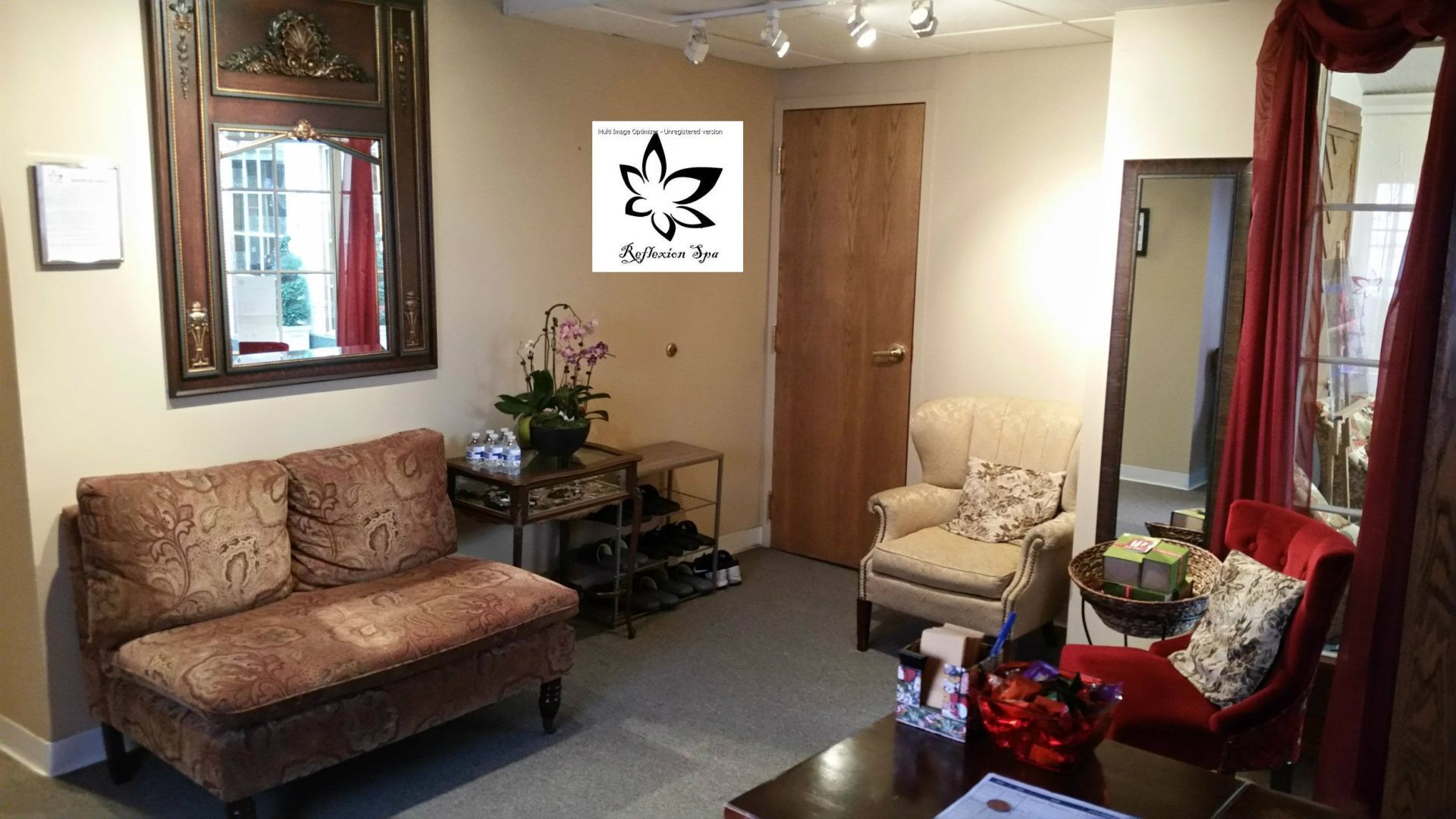 A living room with a couch a chair and a mirror