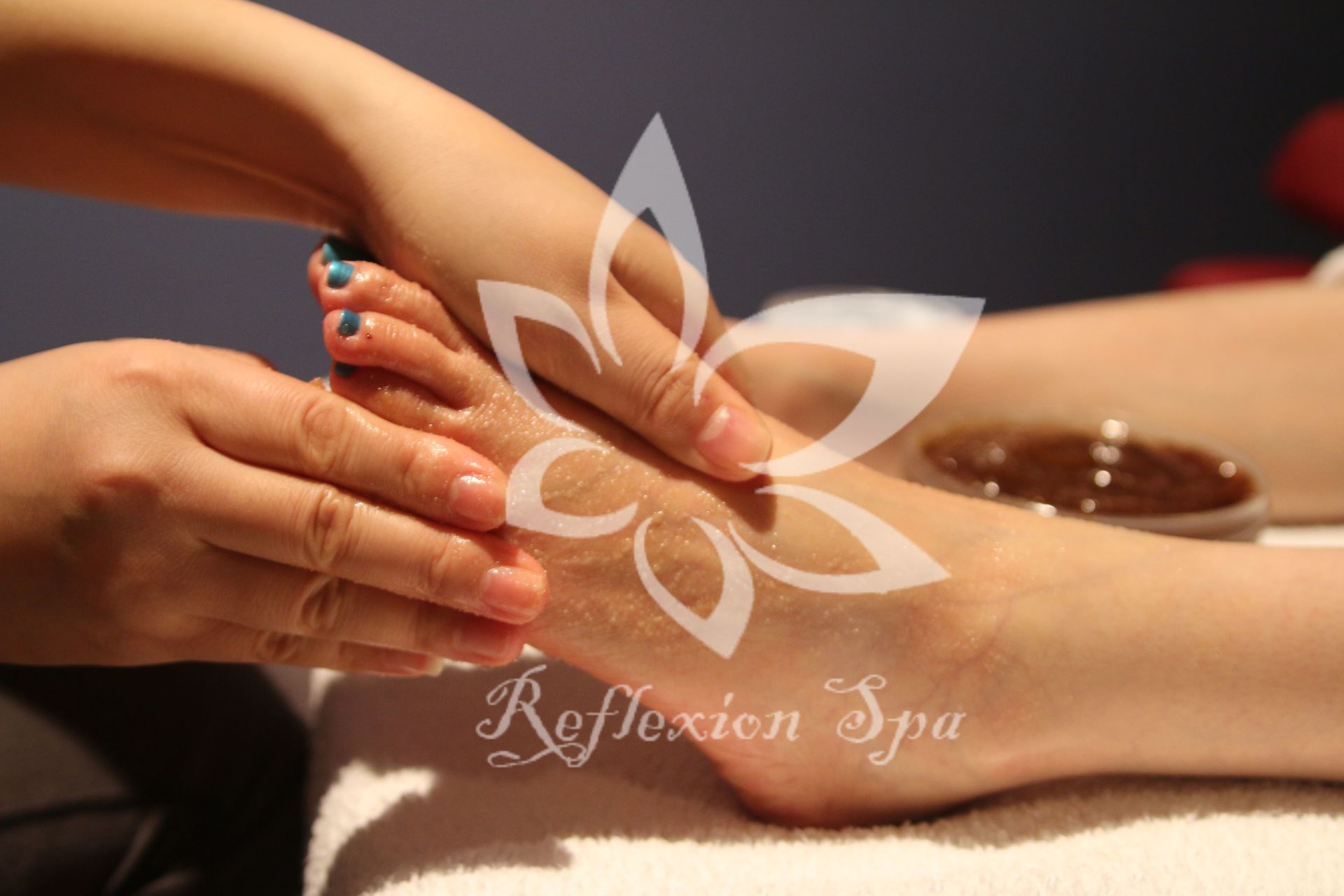 A person is getting a foot massage at reflexion spa