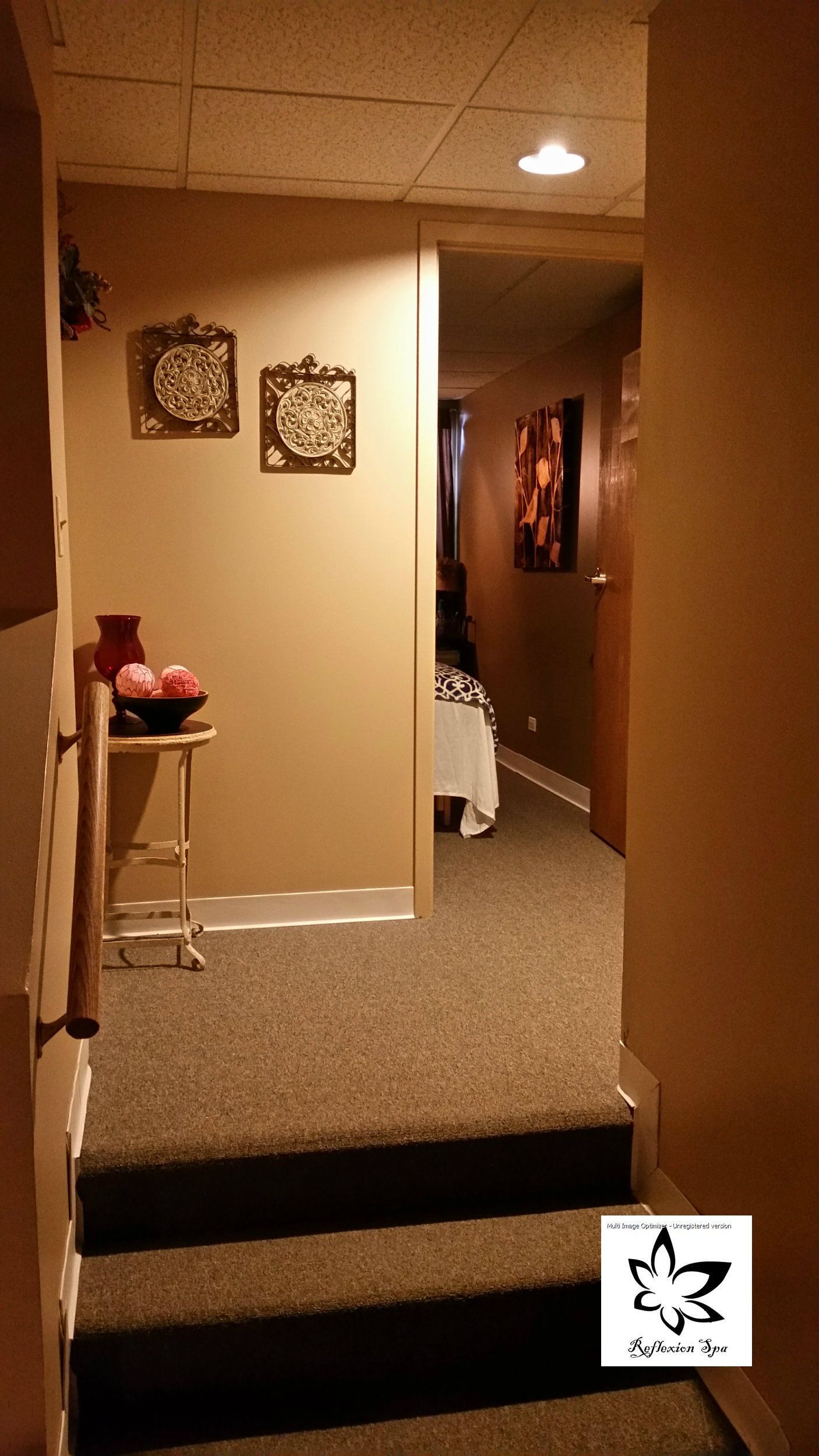 A hallway with stairs leading up to a room