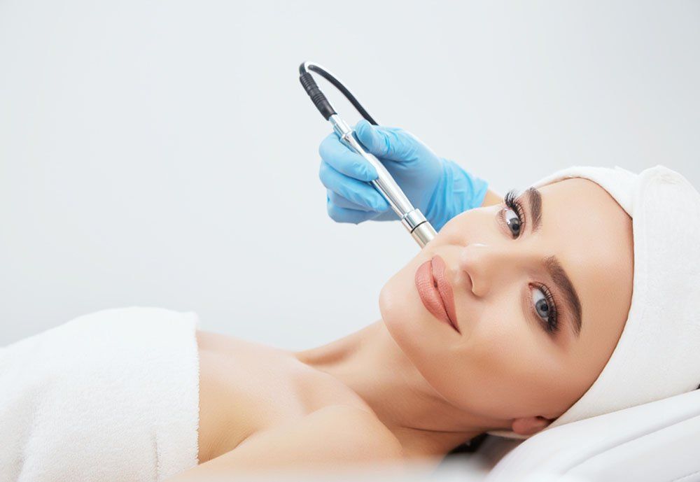 A woman is getting a facial treatment at a beauty salon.