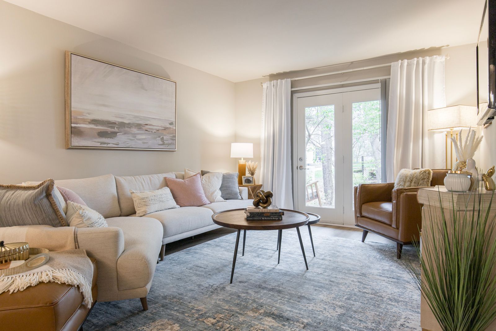 A living room with a couch, chair, coffee table, and sliding glass doors.