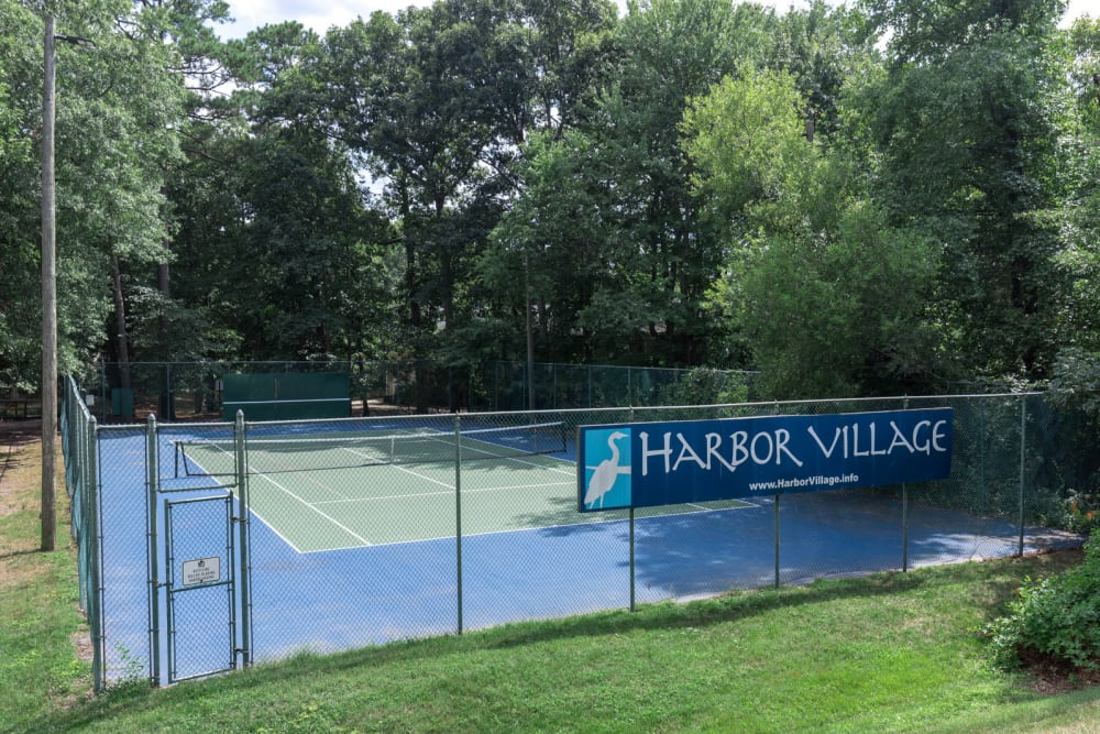 A tennis court with a sign that says harbor village