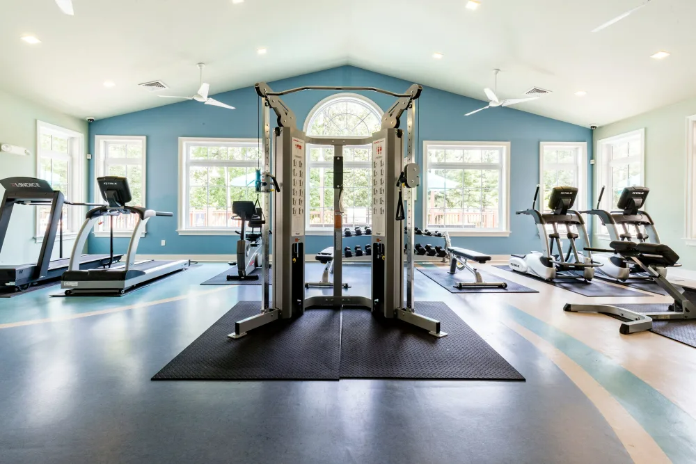 High-ceiling fitness center with workout equipments. 