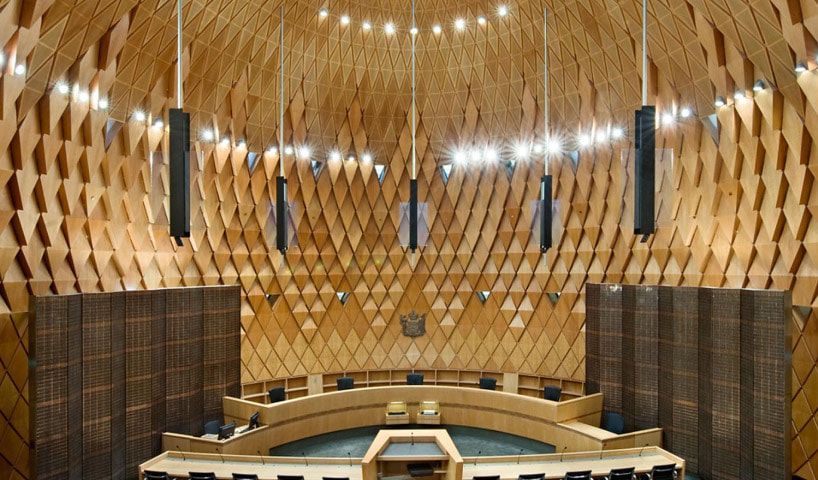 The circular chamber of the Supreme Court of New Zealand, featuring a high, geometric wooden lattice dome and tiered seating.
