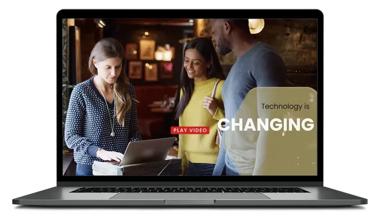 A laptop screen shows a group of people standing around a table looking at a laptop.