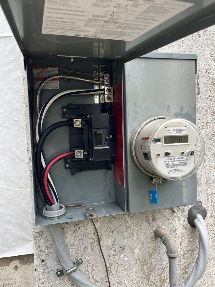 An electrical box with a meter inside of it