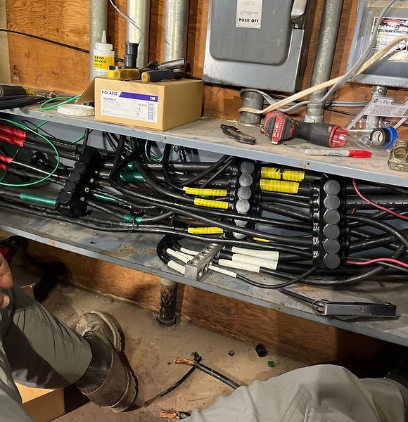 A man is working on a bunch of wires in a room