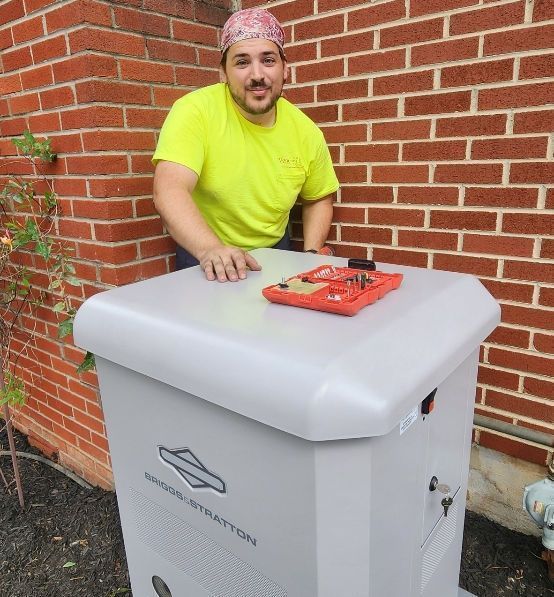 A man in a yellow shirt is leaning against a brick wall
