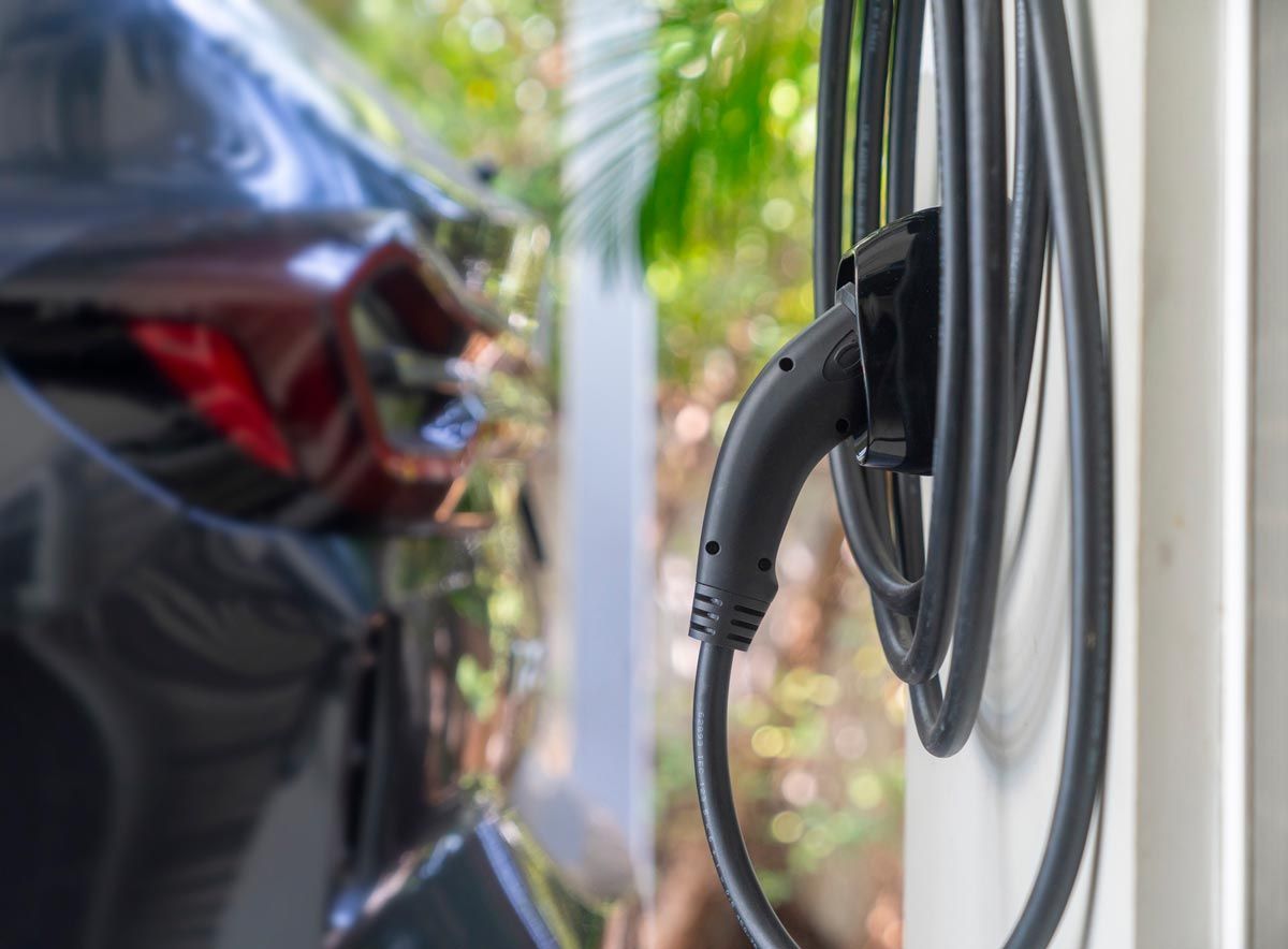 An electric car is being charged at a charging station.