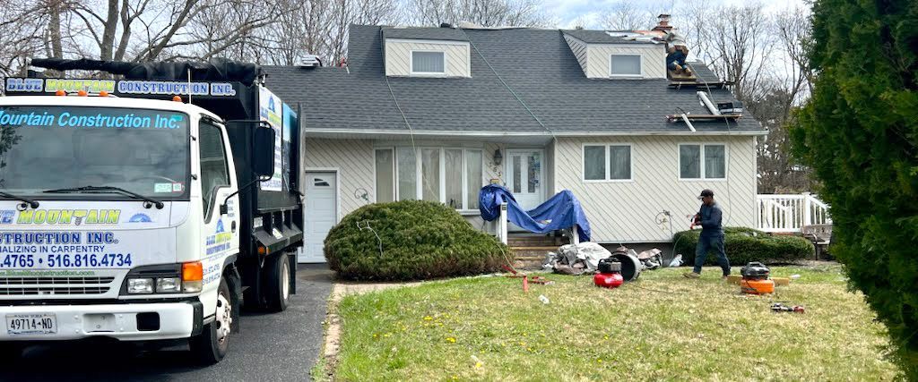 A truck is parked in front of a house.