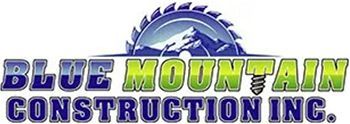 A logo for blue mountain construction inc. with a saw blade