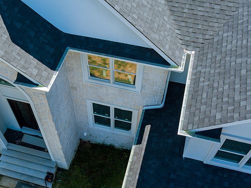 An aerial view of a house with a roof and windows.