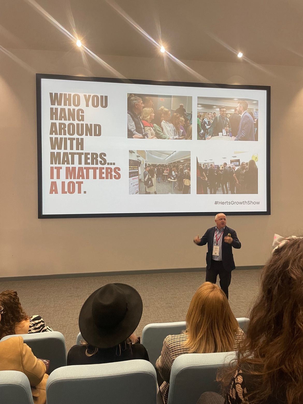 Peter Barker is giving a presentation to a group of people in an auditorium.