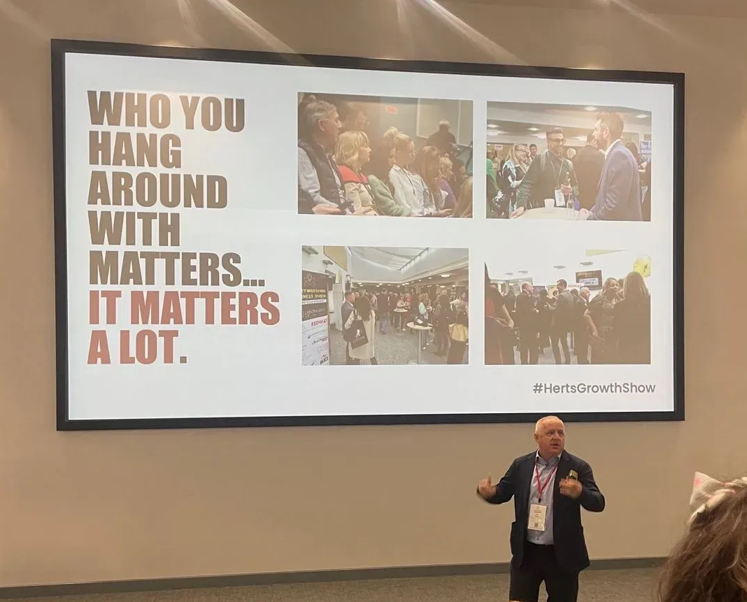 Speaker gestures at a slide: 