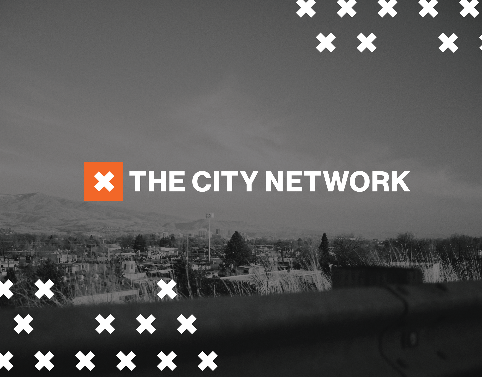 A black and white photo of a city and the words the city network