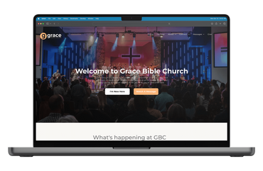 A laptop computer is open to a website for grace bible church.