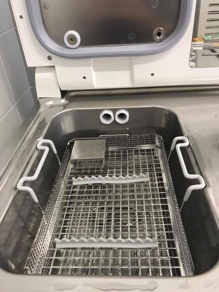 Un lavello in acciaio inossidabile con un vassoio di metallo al suo interno.