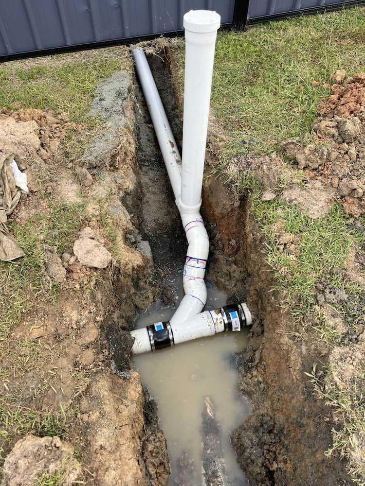 Underground Plumbing Pipes in Muddy Trench — Primed Plumbing & Gasfitting in Eglinton, NSW