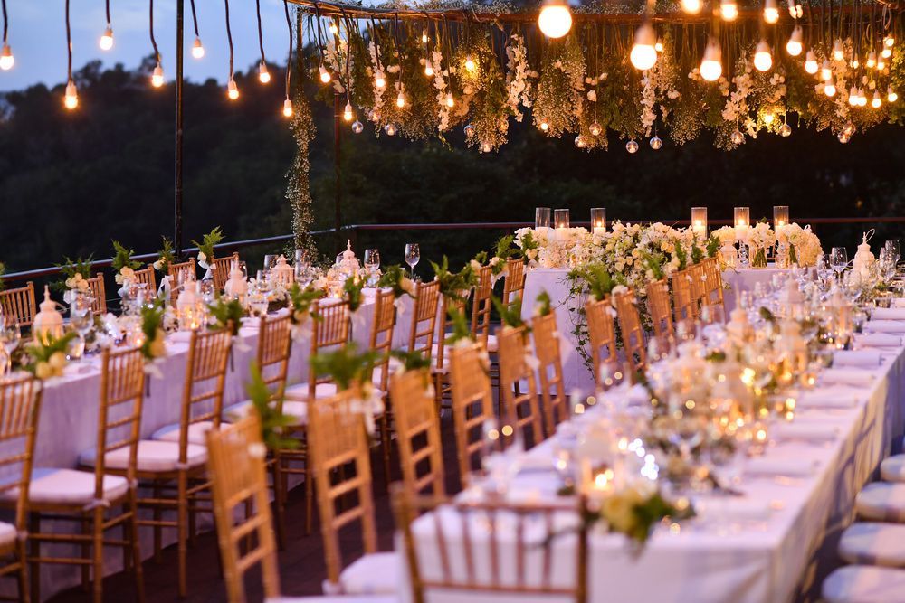 A long table and chairs are set up for a wedding reception.