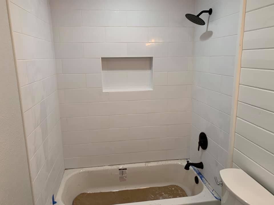 A bathroom with a bathtub and a shower.