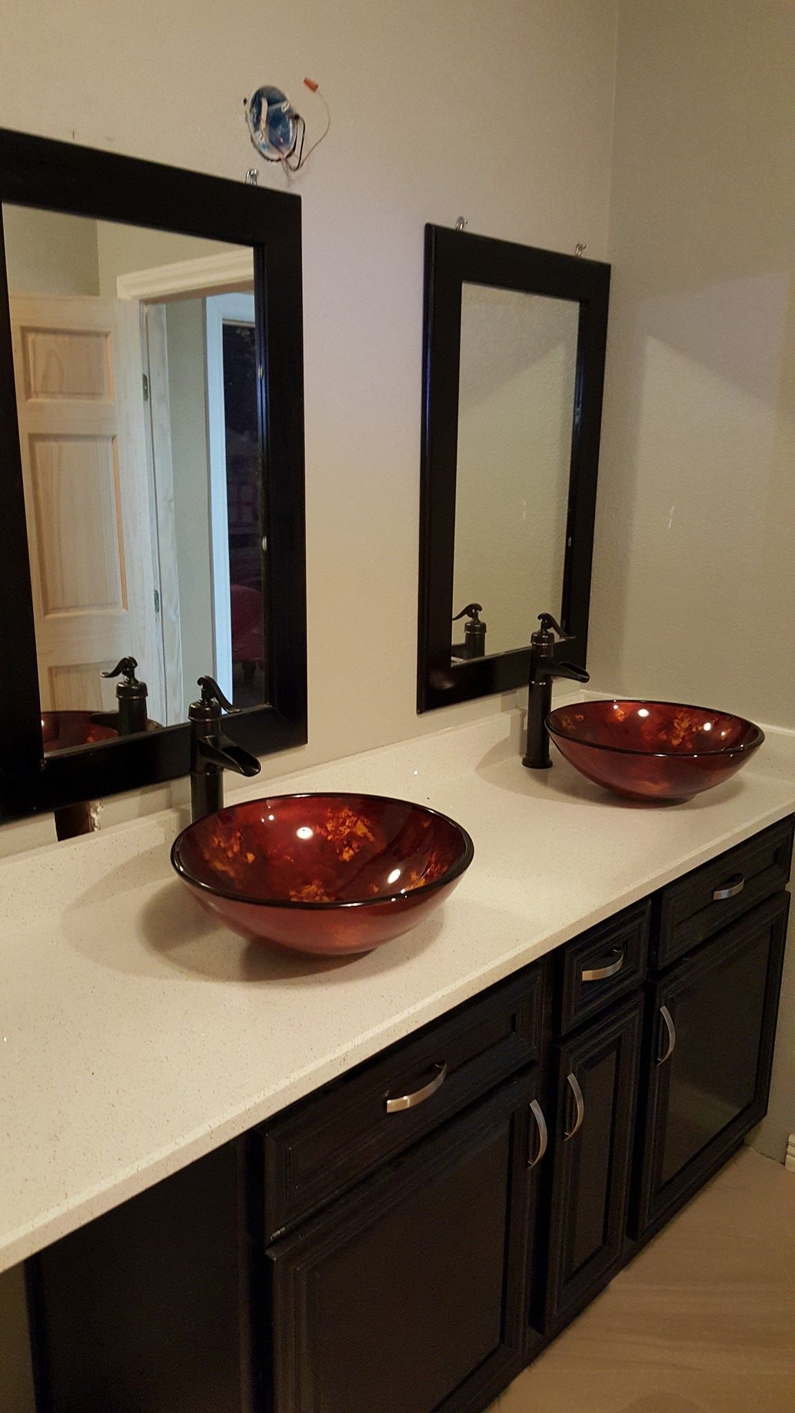A bathroom with two sinks and two mirrors.