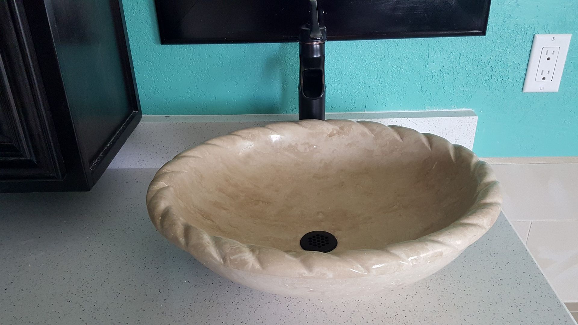 A bathroom sink is sitting on top of a counter.