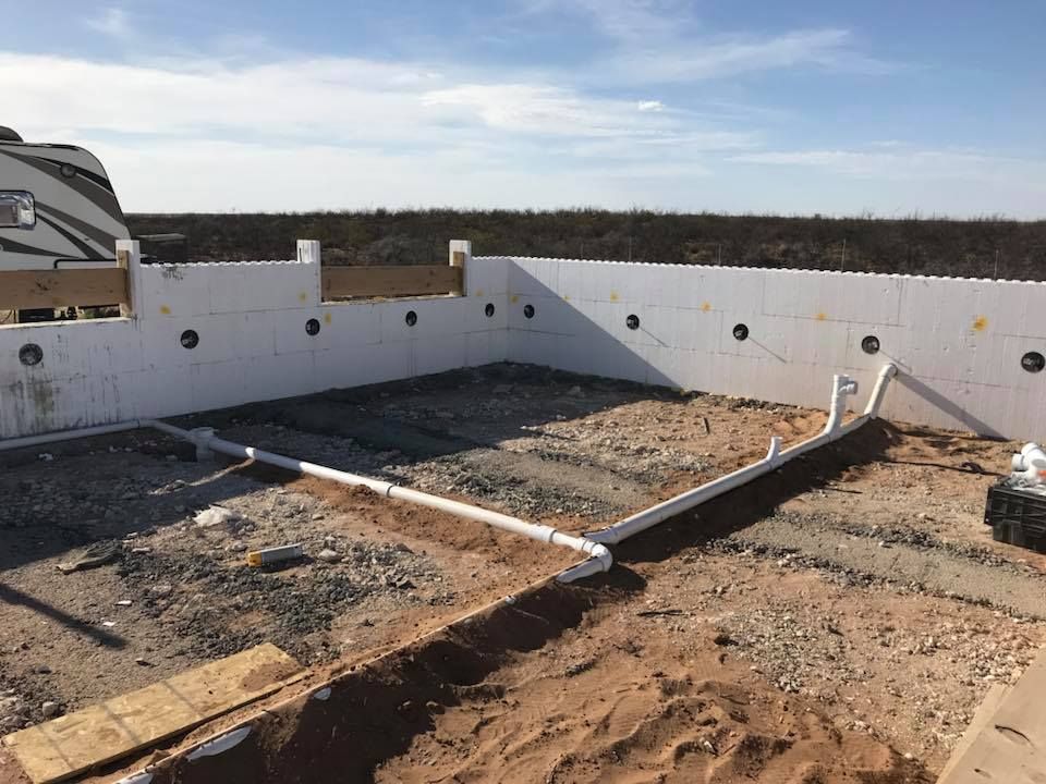 A rv is parked in the background of a construction site.