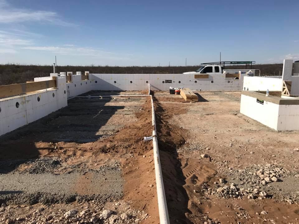 A construction site with a white truck in the background