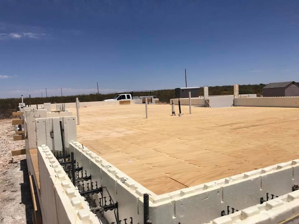 A building under construction with a blue sky in the background.