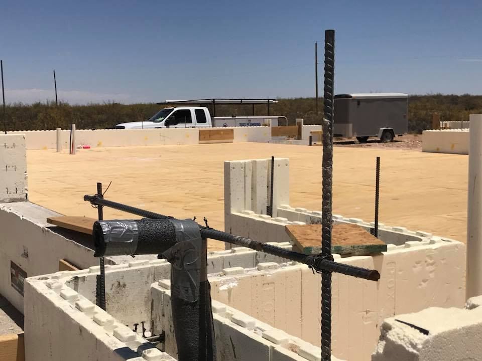 A construction site with a truck parked in the background